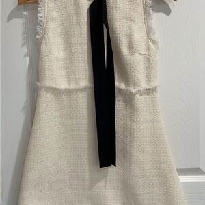 Chic Sleeveless Cream Dress with Black Accent